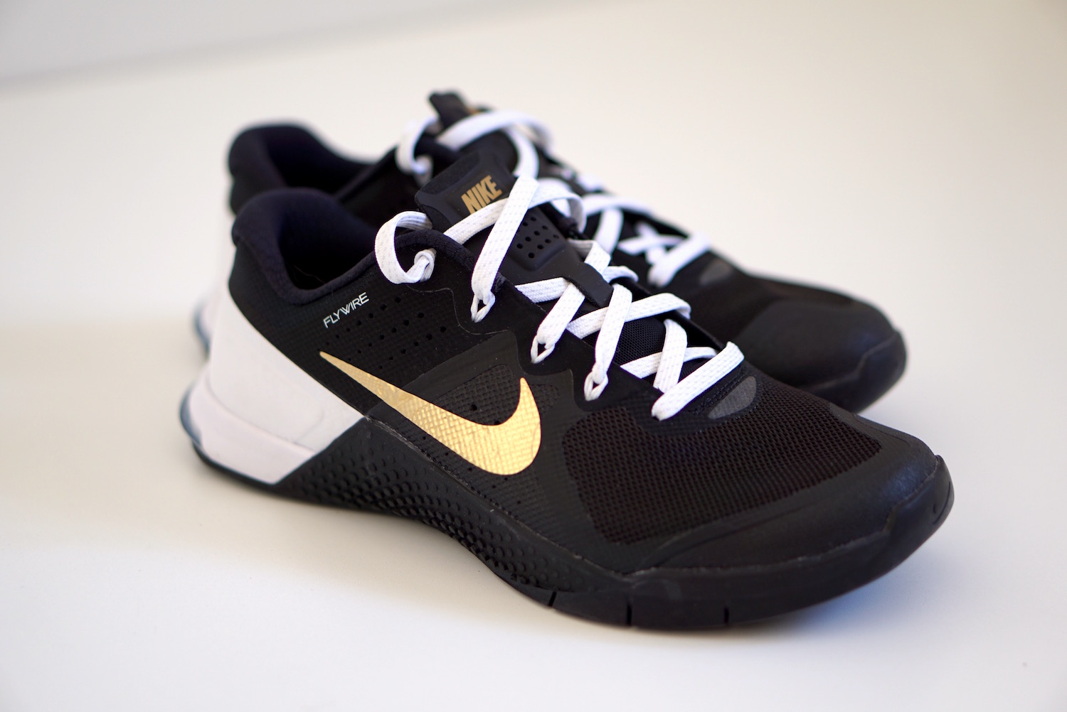 nike metcon gold and black